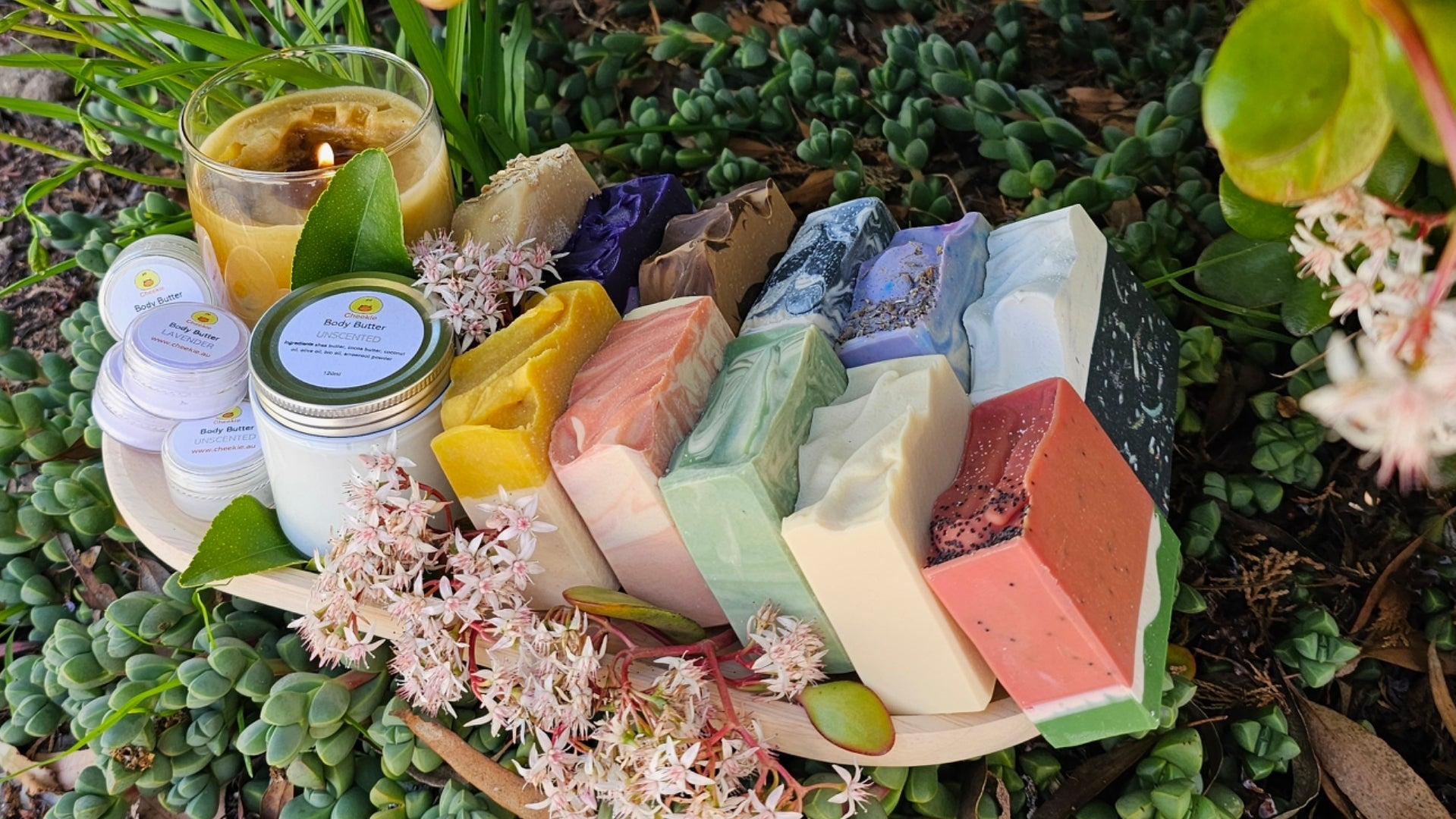 Tray of assorted soaps, body butter and candle